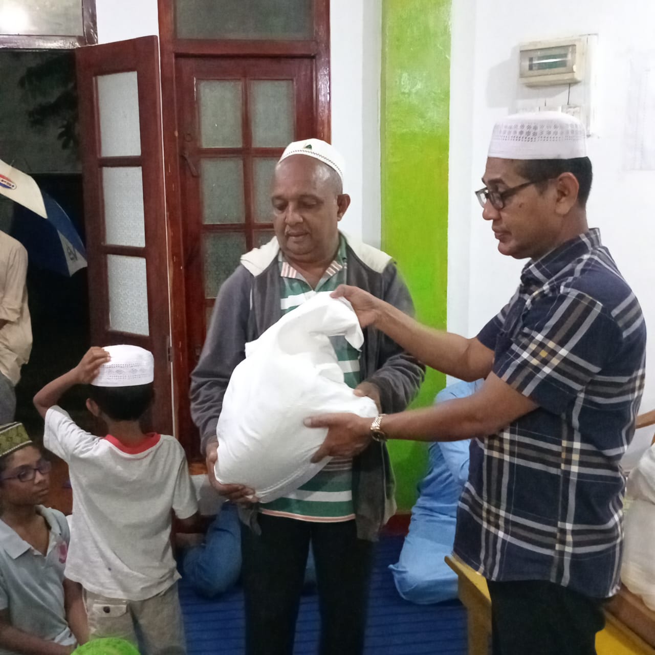 Community food pack handover during Ramadan