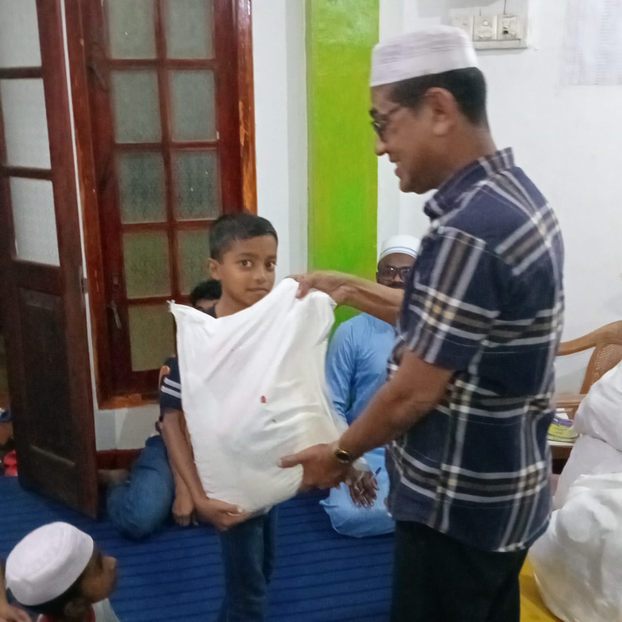 A child receiving essential provisions during Ramadan