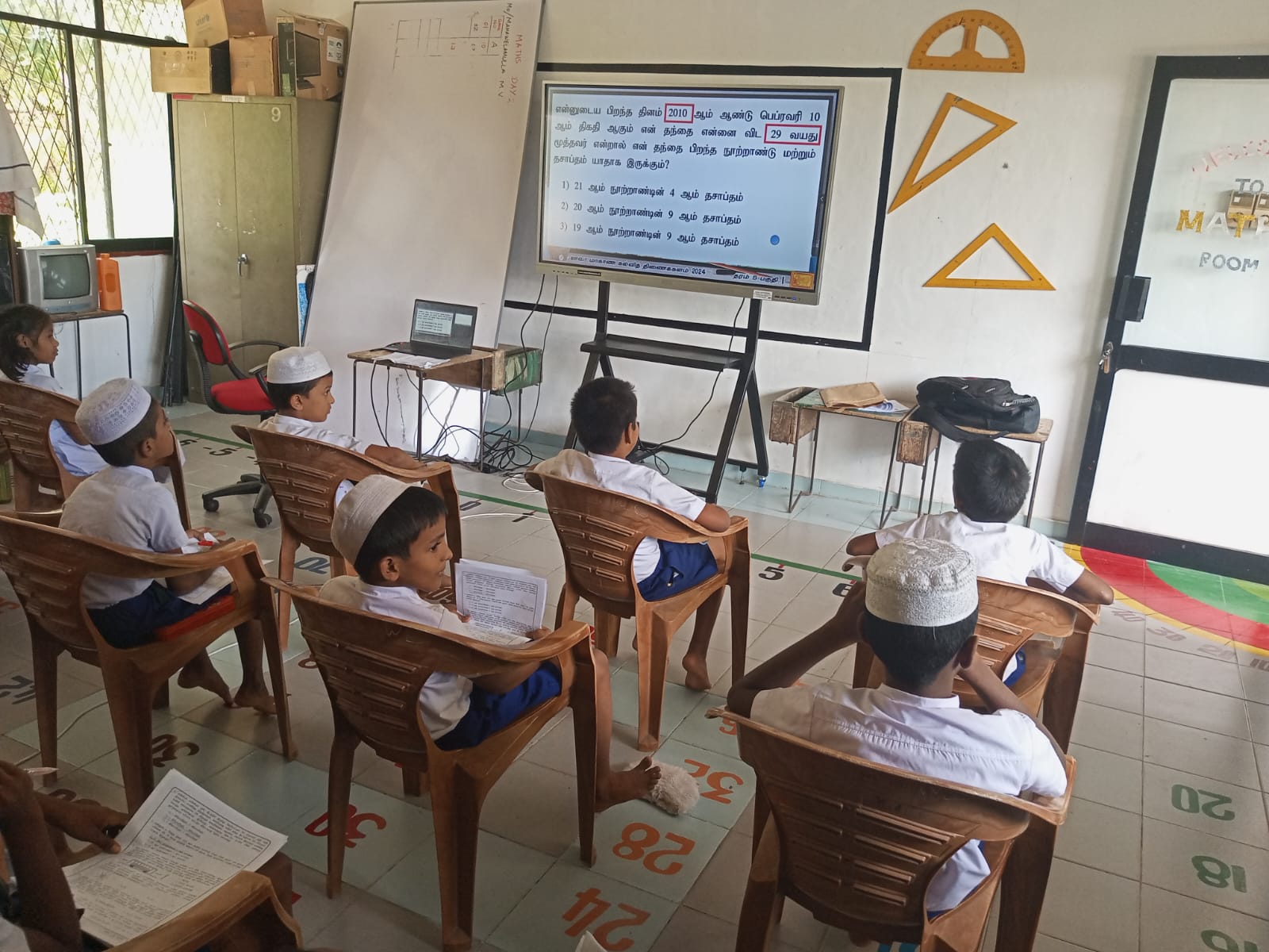 Students learning from a digital screen