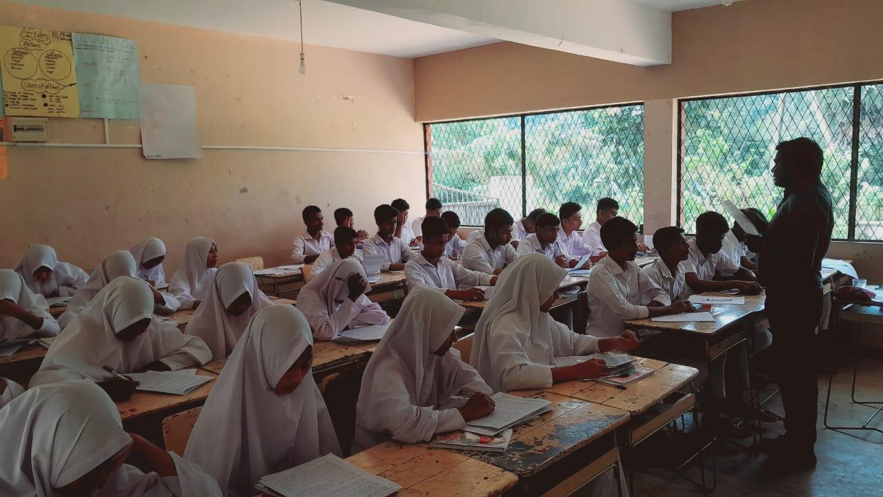 Lecturer guiding students during Tamil revision